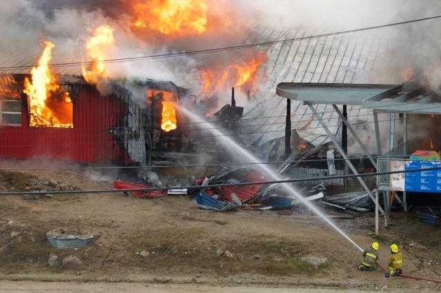 Firefighters work to douse flames coming from Peter Pitseolak school in Cape Dorset Sept. 6. Police have now confirmed the fire was deliberately set. (PHOTO COURTESY OF JOHN CORKETT)
