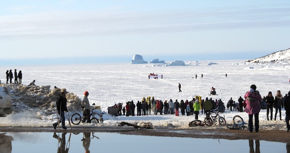 Residents of Qikiqtarjuaq gather by the community's shoreline for a 2013 event. With federal support, the Government of Nunavut is launching a major TB screening clinic in the Baffin community starting Feb. 5. (FILE PHOTO)