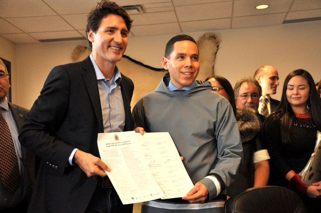 Natan Obed, president of Inuit Tapiriit Kanatami, with Prime Minister Justin Trudeau in Iqaluit on Feb. 9, 2017, when they signed the landmark Inuit-Crown partnership agreement. One of the Inuit priorities communicated through that process is federal government action on combating tuberculosis, which led to a $27.5-million commitment yesterday on the elimination of TB from Inuit Nunangat. (FILE PHOTO)