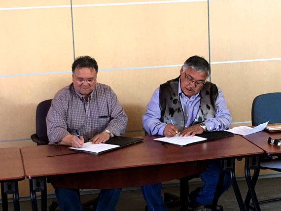 Peter Taptuna, who then served as premier of Nunavut, and Stanley Anablak, the president of the Kitikmeot Inuit Association, sign a memorandum of understanding on July 10, 2016, within which the two sides teamed up to champion the Grays Bay Road and Port Project. The MOU contained a clause that said either side may withdraw from the arrangement by giving 30 days written notice to the other party. (FILE PHOTO) 
