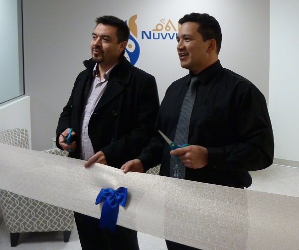Makivik Corp. treasurer Andy Pirti and Nuvviti board member Tommy Palliser prepare to cut the ribbon at Nuvviti's new Montreal office opening in March. Just a year into its operations, Nuvviiti is already undergoing some restructuring. (PHOTO COURTESY OF MAKIVIK)