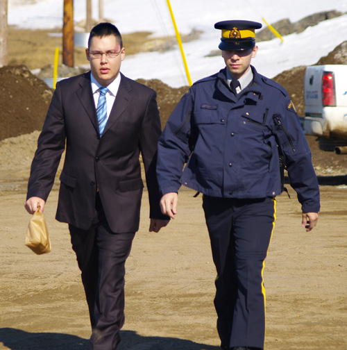 Chris Bishop is led into the Iqaluit courthouse before the start of trial May 26. Bishop faces three counts of murder and two counts of attempted murder in connection with a shooting in Cambridge Bay in January, 2007. (PHOTO BY CHRIS WINDEYER)