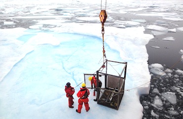 While the Amundsen is travelling in heavy multi-year ice on the afternoon of Aug. 9, the icebreaker stops to sample the ice. Three researchers are let down in a metal box to an ice pan in the Larsen Sound where they drill an ice core which will provide information, among other things, about the ice temperature. (PHOTO BY JANE GEORGE)