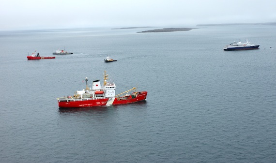 With the help of four commercial tugs, the cruise ship Clipper Adventurer was freed from its grounding Sept. 14 in Nunavut's Coronation Gulf. The ship, which ran aground August 27, was towed late Sept.14 to Port Epworth, a small protected bay approximately 25 nautical miles south of where the ship went aground. The Canadian Coast Guard  icebreaker Sir Wilfrid Laurier is seen here monitoring the first attempt to refloat the vessel on Sept. 11. (PHOTO CCG)