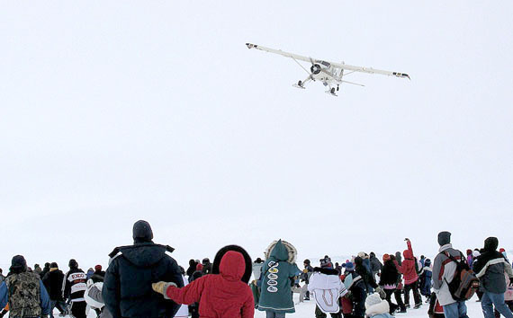 The renowned Nunavik pilot, Johnny May, drops candy at a community event in Kangirsuk in 2006. May is famous throughout the eastern Arctic for his “candy drops.” (FILE PHOTO)