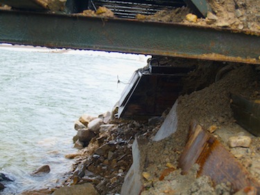 This photo shows erosion under the bridge, with the furthest support washed out from underneath. (PHOTO COURTESY OF THE HAMLET OF CAMBRIDGE BAY)