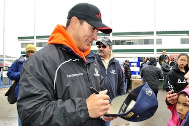 Nashville Predators forward Jordin Tootoo signs autographs at Nunavut Day celebrations in Iqaluit July 9. Tootoo's smashmouth style of hockey has earned him plenty of fans in football-crazy Nashville. (PHOTO BY JIM BELL)
