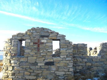 Father André Steinmann worked with his fellow missionaries and locals to build the stone church in Cambridge Bay, seen here from the back — after a 2006 fire, only its walls remain. (PHOTO BY JANE GEORGE)