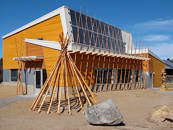 The poles lined up across the front of the new community science centre in the twin communities of Kuujjuaraapik and Whapmagoostui reflect those of a deconstructed tipi. These poles are actually pipes called thermosiphons, which keep the ground frozen under the building and evacuate heat. (PHOTO COURTESY OF FGMDA)

