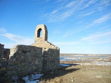 The front of the stone church built by Father André Steinmann in 1954 faces the old town site of Cambridge Bay, later moved to a site across the bay. (PHOTO BY JANE GEORGE)