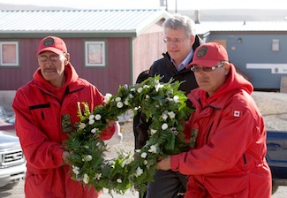 Prime Minister Stephen Harper is joined by members of the Canadian Rangers as he prepares to present a wreath to the Tabitha Mullin, mayor of Resolute Bay, on Aug. 23. (PHOTO BY DEB RANSOM)