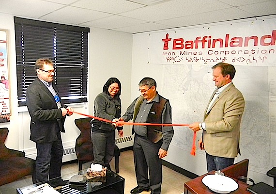 Erik Madsen, Baffinland Iron Ore Corp.’s vice-president of sustainable development, health, safety and environment (left), and Greg Missal, Baffinland’s vice-president of corporate affairs (right), hold the ribbon April 17 as Madeline Redfern, the mayor of Iqaluit, and Joe Tigullaraq, Baffinland's lqaluit manager, slice through the ribbon to officially open the downtown offices for the iron mine project in Iqaluit. At the opening, Missal also presented the Iqaluit food bank with a cheque. Baffinland's Mary River iron mine project moves into the final hearing stage this July. (PHOTO BY JANE GEORGE)