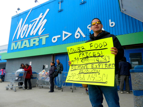 A lone voice. Luc Peter of Iqaluit stands in front of the Iqaluit Northmart store at around 5:15 p.m. May 25, protesting food prices and the sale of expired products. Peter had posted a message on the Iqaluit Public Service Announcement page earlier that day announcing a plan to protest in front of Northmart, but no one else joined him. Despite the low turnout, Peter said that won't deter him. 