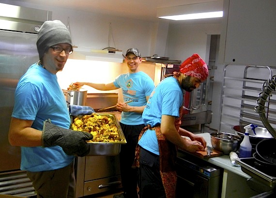 Chef Ken Flatt holds a pan full of Bombay potatoes, while co-chef and brother Jeremy Flatt (right), along with Franco Buscemi (centre), get busy preparing some of the foods on the menu for the March 28 fundraiser curry lunch in Iqaluit for the Food First Foundation, that supports good nutrition in schools. You can enjoy the fundraiser lunch at two sittings: the first at 11:30 a.m., the second at 12:30 p.m. at the Association des Francophones du Nunavut hall at Bldg. 981. Tickets are $25 at the door. Read more about the event on Nunatsiaqonline.ca. (PHOTO BY JANE GEORGE)