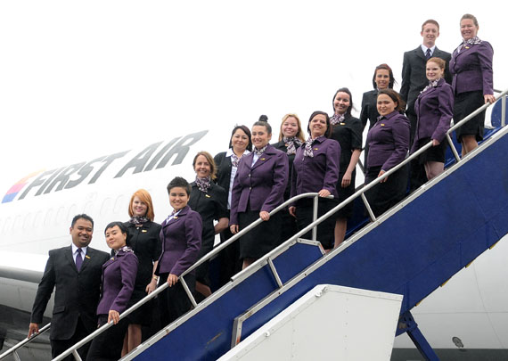 First Air’s new flight attendant trainees pose for a picture on a passenger boarding staircase in front of the airline’s Boeing 767 freighter. (PHOTO COURTESY OF FIRST AIR)