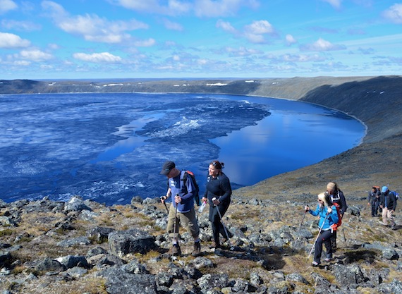 A group of travel writers and operators from the United Kingdom hike to Nunavik's Pingualuit crater last week — one of the highlights of their July 24 to July 30 trip to Nunavik. After a short break at the top of the crater, the group headed down to the lake, where they listened to the remaining ice crackle under the warm rays of the sun. While heading back to  camp, they met groups of caribou with their calves. Read more about the UK visitors' impressions of Nunavik on Nunatsiaqonline.ca. (From top to bottom): David Mariott (Bridge & Wickers tour operator), Marion James (Mamartuq catering services), Phoebe Smith and Neil S. Price (Wanderlust Magazine), Pierre Philie (visitor experience Officer for Pingualuit Park) and Markusie Qisiiq (Pingualuit Park director and guide). (PHOTO BY ISABELLE DUBOIS/NUNAVIK TOURISM)
