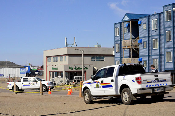Under sunny skies in Iqaluit July 29 members of the RCMP investigate a fatal collision near the intersection where the Arctic Ventures store is located. Police say a pick-up truck hit a young boy early July 29. An ambulance then took the boy to the Qikiqtani General Hospital where he later died. (FILE PHOTO)
