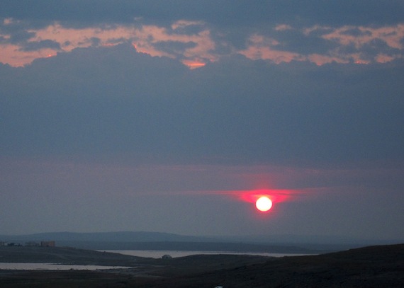 As the sun sets July 28 near Rankin Inlet, smoke in the sky turns the sun into a bright red disc. The smoke comes from fires in Northwest Territories, northern Quebec, Manitoba and Saskatchewan which continue to produce highway shut-downs, health advisories and, in some instances, evacuations.(PHOTO BY DOUG MCLARTY/ ARCTEC DESIGN AND SERVI
