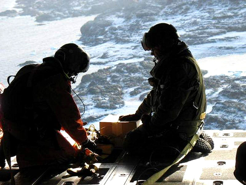 The search and rescue crew on board a CC-130 Hercules from 424 Squadron based at 8 Wing, Trenton, Ont., prepare a radio before dropping it so the stranded hunters could establish ground communications. (PHOTO COURTESY OF DND)