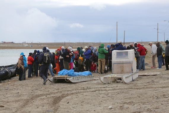 Cruise ship passengers from the Akademik Ioffe gather on the shore of the bay in Cambridge Bay where they toured the town and got a taste of the community's food and culture. (PHOTO BY RED SUN PRODUCTIONS)