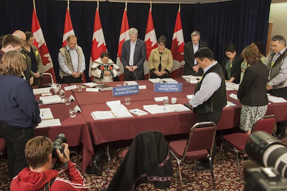A prayer before the Aug. 22 meeting in Rankin Inlet between Inuit leaders, Prime Minister Harper and government officials gets underway. (PHOTO BY DOUG MCCLARTY/ ARTEC DESIGN AND SERVICES)