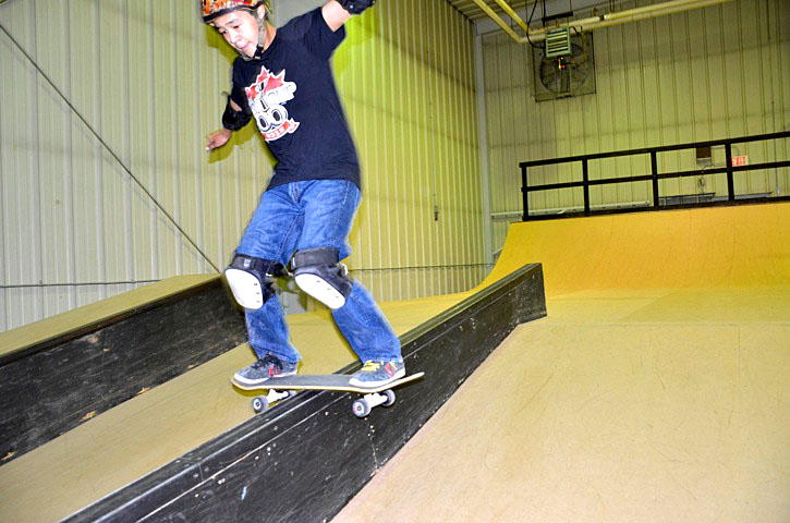 Isaac Idlout, 16, slides down a rail at the Iqaluit skate park Aug. 28 as part of a summer skate camp put on by the City of Iqaluit. The camp runs until Aug. 30 and ends in a competition. (PHOTO BY DAVID MURPHY)