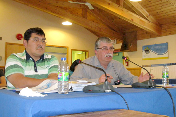 Bernie MacIsaac, director of lands and resources for the Qikiqtani Inuit Association, right, with Cape Dorset representative Olayuk Akesuk, describes the lack of support for oil and gas development among communities of the Baffin region at the association’s annual general meeting, Oct. 11. “We have to take into consideration what people in communities think about this,” he said. (PHOTO BY PETER VARGA)