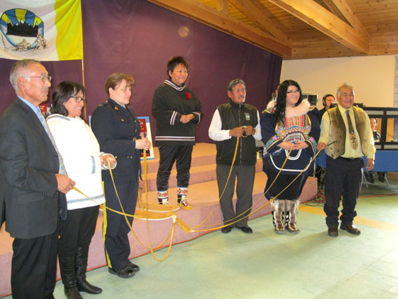 Okalik Eegeesiak, president of the Qikiqtani Inuit Association, poses for a photo with representatives of the federal and territorial governments, the RCMP, and QIA youth and elder representatives at a ceremony held during the release of a two-volume report by the Qikiqtani Truth Commission in Iqaluit, Oct. 9. (PHOTO BY PETER VARGA)