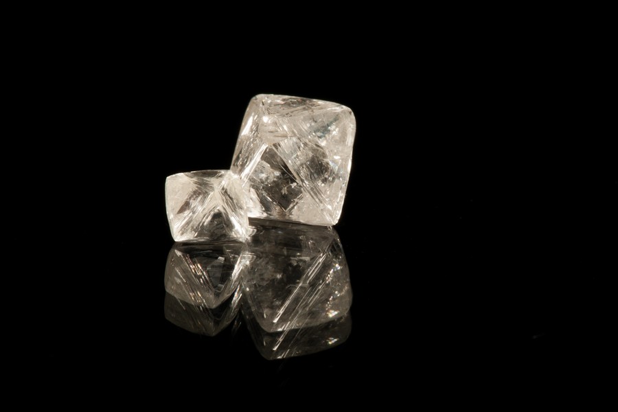 These two octahederal, or eight-sided, diamonds are among those recovered at the Saskatchewan Research Council from a 222.1 dry tonne bulk sample extracted this past summer from Peregrine Diamonds' Chidliak site about 120 kilometres northeast of Iqaluit, at a kimberlite pipe known as CH-6. In an announcement Dec. 3, Peregrine said they recovered 48 diamonds greater than one carat in size, and 137 diamonds greater than half a carat, and that the recovery process revealed a grade of 2.70 carats per tonne. Peregrine said this confirms that CH-6 may be one of the highest grade kimberlite pipes in the world. The diamond on the right in this photo, the largest of those recovered, weighs in at 3.54 carats. Read more later on Nunatsiaqonline.ca. (PHOTO COURTESY OF PEREGRINE DIAMONDS)