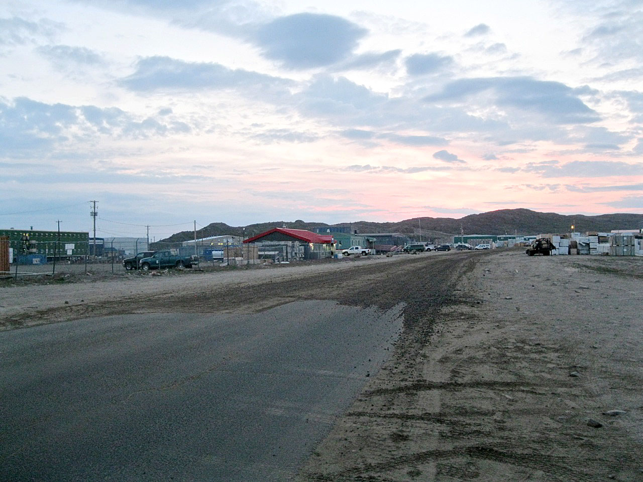 A view of Iqaluit's Federal Road last summer. Arctic Infrastructure Partners, builder of the territorial government’s $300 million Iqaluit airport construction project, has agreed to cover part of the cost of repairing Federal Road from the city centre to the North 40 area. (PHOTO BY PETER VARGA)
