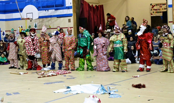 Participants at the Christmas Games in Pangnirtung Dec. 27 had to team up in twos and dress their partners like Santa. Teams had only gift wrap, tinsel garland, tape and ten minutes to create their Santas, who stood on display for the Games crowd afterwards to show off the final product. (PHOTO BY SARAH MCMAHON) 

