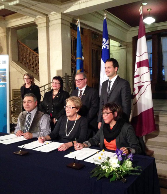 The Quebec government and Nunavik leaders jointly announced new money to offset Nunavik's high cost-of-living Dec. 9 in Quebec City. In the front row, from left, is Makivik Corp. president Jobie Tukkiapik, Quebec Premier Pauline Marois and KRG chair Maggie Emudluk. (PHOTO BY MARY PILURTUUT/KRG) 