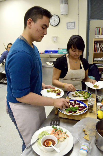 Skills Nunavut cooking club members Simeonie Kisa-Knickelbein and Tooma Dianna Laisa enjoy the fruits of their labour. (PHOTO BY JIM BELL) 