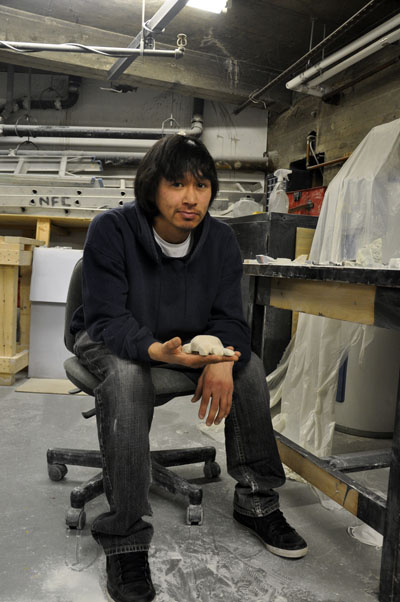 Simiuni Nauya, inside the carving room at the Native Friendship Centre of Montreal, showing the progress he’s made on a small turtle sculpture. (PHOTO BY SARAH ROGERS) 