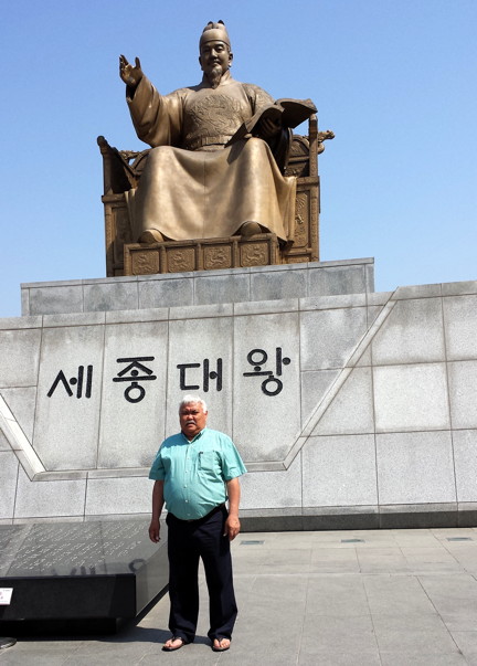 Storyteller and author Michael Kusugak stands in front of a statue of King Sejong in the centre square of Seoul, the capital of South Korea. (PHOTO COURTESY MICHAEL KUSUGAK)