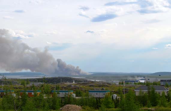 A June 22 fire outside of Kuujjuaq quickly spread, sending black smoke over the community of 2,200. (PHOTO BY ERIC DUCHESNEAU) 