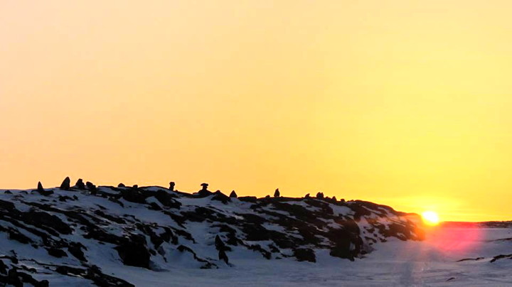 The sun sets beyond a hill dotted with inuksuit outside of Repulse Bay in this photo taken by native Repulse Bay elder Piita Irniq. The Repulse Bay hamlet council has submitted an official request to the Nunavut government to change its name to its traditional Inuktitut moniker: Naujaat. (PHOTO BY PIITA IRNIQ)