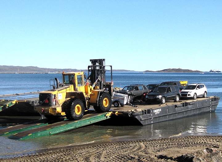 A barge-load of vehicles hits Iqaluit’s beach during the 2013 sealift. The city’s ballooning population of vehicles raised questions and concerns at an Aug. 26 council meeting. (PHOTO BY PETER VARGA)