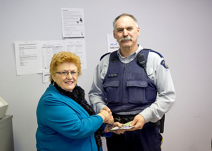 Joyce Ayaruak presents Rankin Inlet RCMP Sgt. Kim Melenchuk with a cheque for $1,340, proceeds from table rentals at the recent Rankin Inlet craft sale, to go toward the annual RCMP Christmas hamper fund. Running annually since 1996, the hamper fund provides food certificates of up to $250 to some 200 families and needy individuals to buy food for the holidays. Local businesses and individuals contribute to the fund throughout the year and this year, Maani Ulujuk Illinniarvik students are raffling off a TV. Rankin Inlet residents who want to be considered for a hamper can contact the local RCMP detachment. (PHOTO BY DOUG MCLARTY/ARCTECH DESIGN AND SERVICES) 