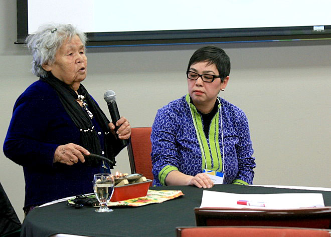 Enoapik Sageatook officially opens the fall 2014 gathering of the Nunavut Roundtable for Poverty Reduction at the Frobisher Inn in Iqaluit with a ceremonial qulliq-lighting, Nov. 26, as conference moderator Karliin Aariak looks on. The three-day conference has drawn about 85 delegates from the territory’s 25 communities to discuss poverty-reduction strategies for Nunavut. Among them are representatives of regional Inuit associations, wellness centres, municipal governments, and the Government of Nunavut whose work focuses on justice, social assistance and community healing. (PHOTO BY PETER VARGA)