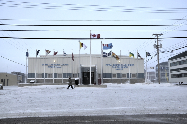 A pedestrian hurries across the parking lot at the Canadian Legion over the lunch hour Dec. 1 in Iqaluit, where wind gusts of up to 70 km/h are creating a windchill that makes it feel -45 C in Nunavut's capital today. The wind, expected to last into the night, in combination with blowing snow and ice crystals, is creating low visibility conditions. (PHOTO BY THOMAS ROHNER)