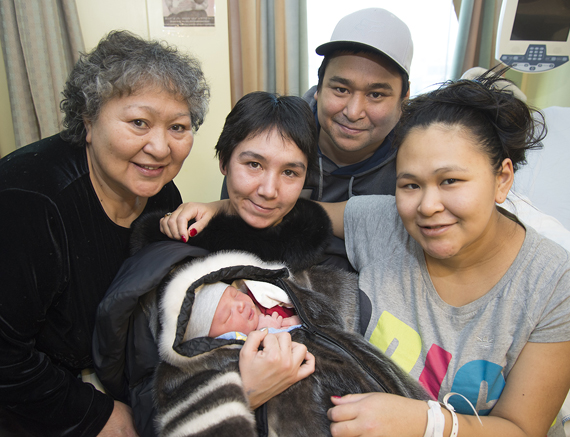 Meet Nunavut's first baby of 2015: Mosesie Mark Parr, who was born Jan. 1 at 2:31 a.m. at Iqaluit's Qikiqtani General Hospital. Pictured with baby Mosesie, from left, his maternal grandmother Lucy Mingeriak, his birth mother Ruthie Mingeriak of Kimmirut and the baby's adoptive parents Jawlie Mingeriak and Tirak Parr, also of Kimmirut. Baby Mosesie weighed in at 9 lbs, 8 oz. (PHOTO COURTESY OF THE GOVERNMENT OF NUNAVUT)