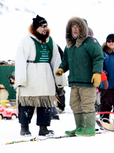 Andrew Porter, at left, and elder Jerome Tattuinee speak at the dog team race held this past weekend as part of Rankin Inlet's Pakallak Tyme spring festival. (PHOTO BY PAGE BURT)