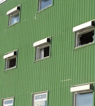 These broken windows on the second floor at the back side of the Ukkivik residence show where the fire, which started at about 10:30 p.m., broke out. (FILE PHOTO)