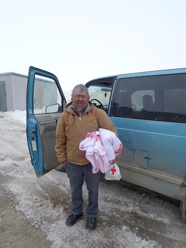 Jamesie Shoo gets ready to head to work from the shelter that Red Cross workers and Iqaluit's recreation department opened at the Makkuttukkuvik Youth Centre inside the Arctic Winter Games facility. (PHOTO BY JANE GEORGE)