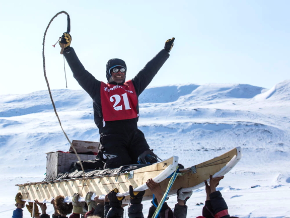 Jake Gearheard is hoisted into the air as he crosses the Nunavut Quest finish line in Arctic Bay, as is the custom for each musher as they complete the 500-km journey from Pond Inlet to Arctic Bay. The 16th annual multi-day event wound down April 27 and Arctic Bay residents gave a warm welcome to all the competitors. The winning team — the one with the shortest combined daily times — will be announced at the race's closing ceremonies tonight, April 28, in Arctic Bay. Andy Attagutalukutuk won last year's race and took home a $15,000 grand prize. (PHOTO BY CLARE KINES) 
