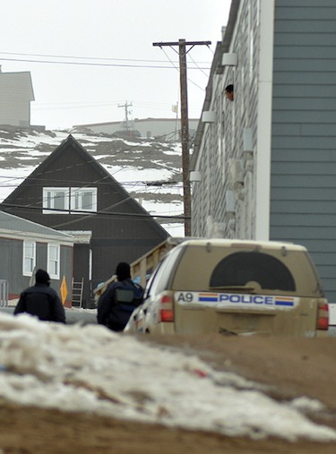 RCMP members walk near a unit in Creekside Village where a man had barricaded himself early May 2. (PHOTO BY THOMAS ROHNER)