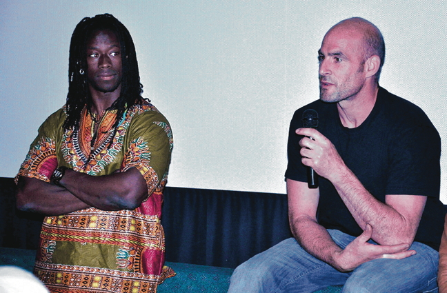 Guillaume Saladin, right, and Yamoussa Bangoura address the audience at the Astro Theatre in Iqaluit June 29 after the screening of a documentary, 