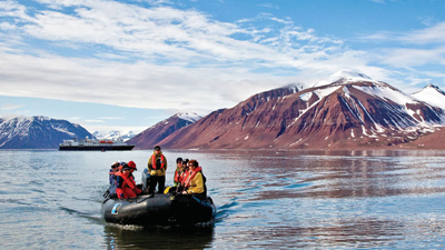 Lindblad Expeditions' National Geographic vessel, pictured in the background, will sail north to Grise Fiord Aug. 27 with 148 tourists aboard. It's one of about a dozen cruise ships scheduled to visit the territory this summer. (PHOTO COURTESY OF LINDBLAD EXPEDITIONS) 