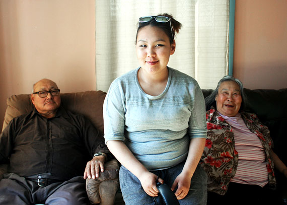 Erica Tungilik (centre) sits between her grandfather, Joseph Akoak, and his wife, Martha Pooyatak, after interviewing them for the Nanivara history project in Gjoa Haven July 2. The project teaches local youth interviewing, research and tech skills as they chronicle their local history. (PHOTO COURTESY OF NANIVARA)
